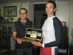 Tim Male in rowing colours receiving from Michael O'Reilly a wooden presentation box containing the Silver Sculls
